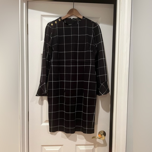 Iman long sleeved dress with fluted sleeves. Black with a white plaid pattern. - Picture 1 of 2